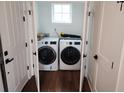 Bright laundry room featuring modern white washer and dryer at 22 Iron Forge Aly, Charleston, SC 29403