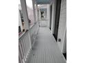 Exterior balcony with painted wood floor and white wood trim at 24 Iron Frg Aly, Charleston, SC 29403