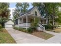 Light green house with a detached garage and driveway at 524 Shem Butler Ct, Charleston, SC 29414