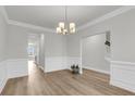 Elegant dining room featuring hardwood floors, white wainscoting, and a stylish chandelier at 709 Maynard Ln, Summerville, SC 29486