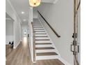 Bright foyer with hardwood floors, white trim, and a staircase leading to the second floor at 709 Maynard Ln, Summerville, SC 29486