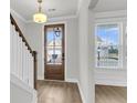 Bright foyer with hardwood floors, white trim, and a glass front door allowing natural light at 709 Maynard Ln, Summerville, SC 29486