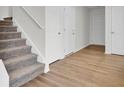 Gray carpeted stairs and light brown wood flooring at 1112 Moss Grove Dr, Moncks Corner, SC 29461