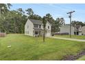 House with tree, driveway, and green lawn at 1625 Pimlico Blvd, Moncks Corner, SC 29461