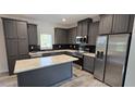 Modern kitchen with gray cabinets, stainless steel appliances, and an island at 392 Dike Rd, Bonneau, SC 29431