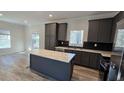 Modern kitchen with gray cabinets, stainless steel appliances, and an island at 392 Dike Rd, Bonneau, SC 29431