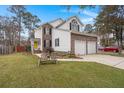Side view of charming two-story house with a spacious yard at 1005 Shinnecock Hills Ct, Summerville, SC 29483