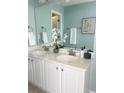 Double vanity bathroom with light teal walls and white cabinets at 1005 Washitonia # C, Charleston, SC 29492