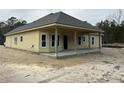 Rear view of new construction home showcasing covered patio at 1081 Irving Manigault Rd, McClellanville, SC 29458