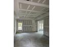 Spacious living room with drywall and new windows at 1081 Irving Manigault Rd, McClellanville, SC 29458