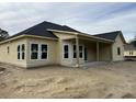 New home with rear covered patio and large windows at 1085 Irving Manigault Rd, McClellanville, SC 29458