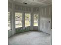 Bright living room with large windows and unfinished walls at 1085 Irving Manigault Rd, McClellanville, SC 29458