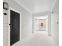 Apartment entry hallway with dark door and fire extinguisher at 130 River Landing Dr # 8203, Charleston, SC 29492