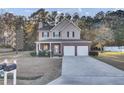 Two-story house with brick and siding, two-car garage, and a porch at 1401 Churchill Rd, Moncks Corner, SC 29461