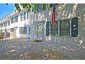 Townhome's entrance with green shutters, American flag, and patio at 15 Horlbeck Aly # A-7, Charleston, SC 29401