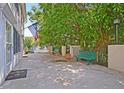 Peaceful patio with green bench, American flag, and lush greenery at 15 Horlbeck Aly # A-7, Charleston, SC 29401