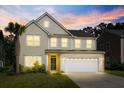 Two story house with lights on at dusk at 440 Coopers Hawk Dr, Summerville, SC 29483