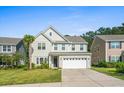 Two-story house with a white garage door and landscaping at 440 Coopers Hawk Dr, Summerville, SC 29483