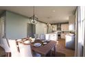 Well-lit dining area with a wooden table and white chairs at 524 Hayes Park Blvd # 3, Johns Island, SC 29455