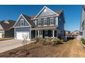 Two-story house with blue siding, white garage door, and a landscaped yard at 602 Yellow Leaf Ln, Summerville, SC 29486
