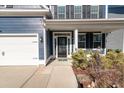Front entry with black door, white columns, and landscaping at 602 Yellow Leaf Ln, Summerville, SC 29486