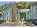 Inviting light green two-story building with brick chimney and parking at 6240 April Pine Cir # B, North Charleston, SC 29406