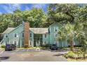 Two-story light green condo building, ample parking and lush landscaping at 6240 April Pine Cir # B, North Charleston, SC 29406