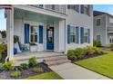 Inviting front porch with a porch swing and brick steps at 645 Blueway Ave, Summerville, SC 29486