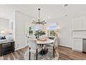 Bright dining area with round table, four chairs, and a chandelier at 741 Meadowbrook Ln, Summerville, SC 29486