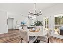 Bright dining room with round table, chandelier, and access to backyard patio at 747 Meadowbrook Ln, Summerville, SC 29486