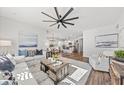 Spacious living room with hardwood floors, large windows, and comfortable seating at 752 Meadowbrook Ln, Summerville, SC 29486