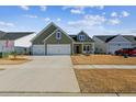 Two-car garage and driveway, house with green siding at 1104 Cooper Point St, Summerville, SC 29485
