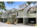 Light green townhome building with attached garages and landscaping at 1704 Live Oak Park, Seabrook Island, SC 29455