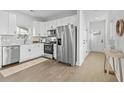 Modern kitchen with white cabinets, stainless steel appliances, and quartz countertops at 1992 Groveland Ave, North Charleston, SC 29405