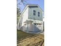 Two-story house with gray and white siding, attached garage, and a well-manicured lawn at 1994 Groveland Ave, North Charleston, SC 29405