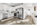 Modern kitchen with white cabinets, stainless steel appliances, and quartz countertops at 1994 Groveland Ave, North Charleston, SC 29405