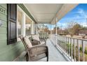 Relaxing front porch with wicker chairs and a porch swing at 2007 Central Ave, Summerville, SC 29483