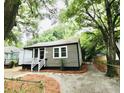Updated bungalow with a gravel driveway and mature trees at 2744 E Surrey Dr, North Charleston, SC 29405