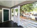 Inviting front porch with white railings and a view of the street at 2744 E Surrey Dr, North Charleston, SC 29405
