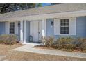 Inviting front porch with white columns, decorative lights, double doors, and manicured landscaping at 303 Longleaf Rd, Summerville, SC 29486