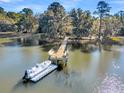 Private dock with boat slip on calm waterway at 6148 Josie Ridge Rd, Wadmalaw Island, SC 29487