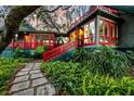 Charming home exterior with red accents and lush landscaping at 6148 Josie Ridge Rd, Wadmalaw Island, SC 29487