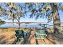 Relaxing waterfront view with two chairs and calm water at 6148 Josie Ridge Rd, Wadmalaw Island, SC 29487