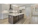 Modern kitchen featuring a large island, white cabinets, and stainless steel appliances at 7210 Raw Dew Dr, Awendaw, SC 29429