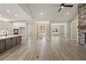 Open concept living area with hardwood floors, stone fireplace, and high ceilings at 7210 Raw Dew Dr, Awendaw, SC 29429