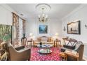 Cozy living room featuring a comfortable sofa, area rug and beautiful artwork at 79 Alexander St, Charleston, SC 29403
