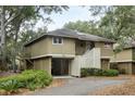 Light beige cottage with private driveway and lush landscaping at 1116 Summerwind Ln, Seabrook Island, SC 29455