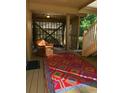 Covered porch with wicker chair and colorful rug at 1116 Summerwind Ln, Seabrook Island, SC 29455