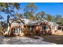 Newly renovated brick home with a large driveway and mature trees at 1216 Taliaferro Ave, Charleston, SC 29412