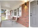 Inviting front porch with brick flooring and two metal chairs at 127 Roberts Rd, Summerville, SC 29483